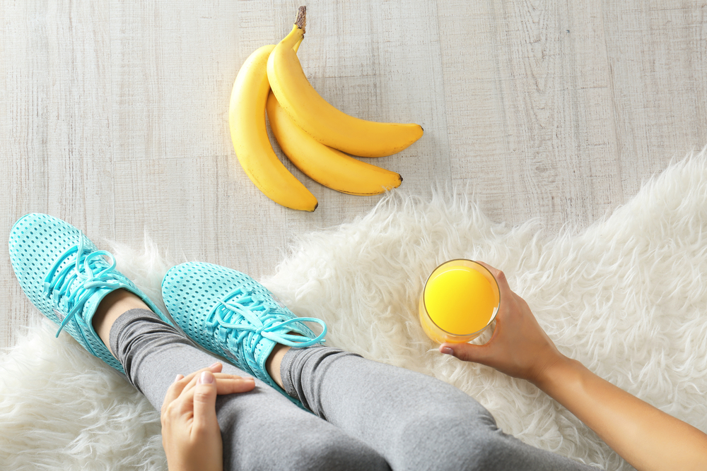 Girl with bananas laying on the floor.