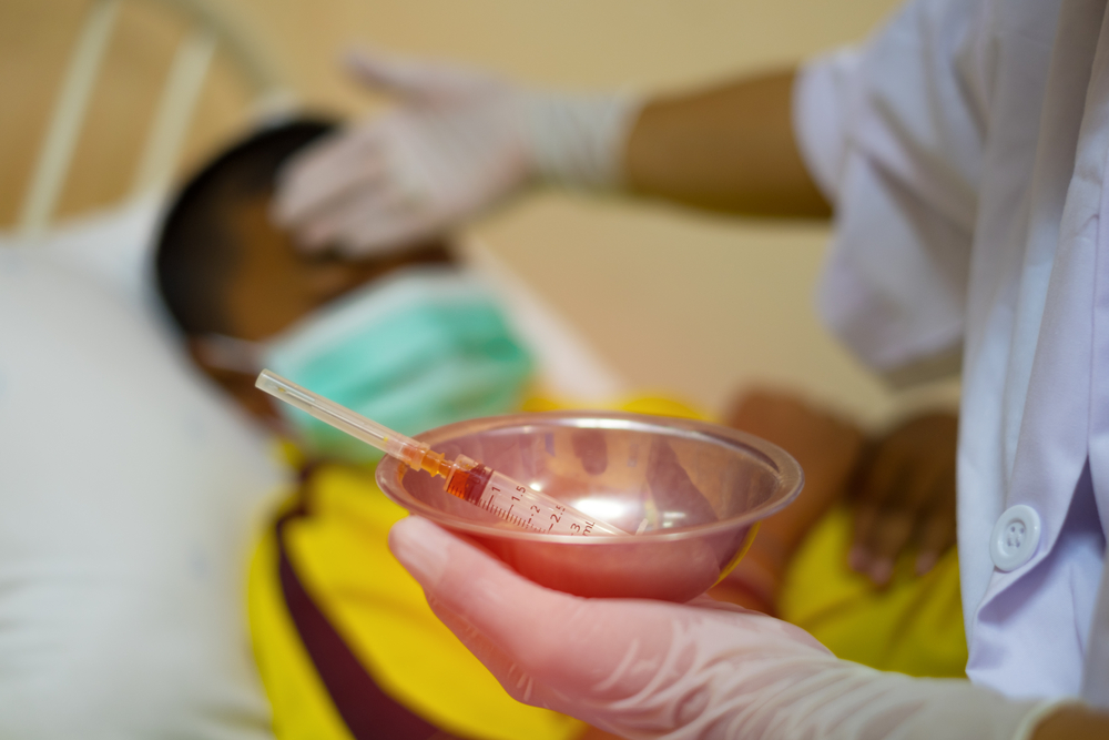 Boy receiving vaccine treatment.