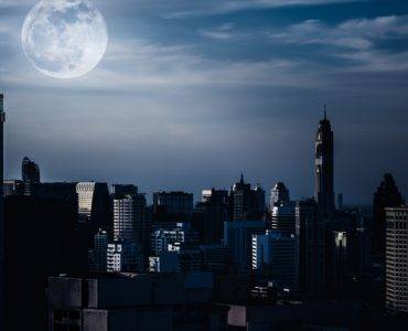 Dark skyscrapers in moonlight