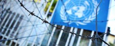 United Nations flag and barbed wire