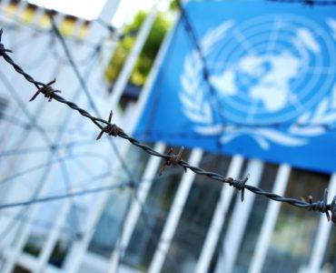 United Nations flag and barbed wire