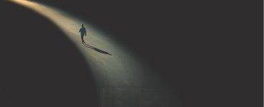 Man walking on lighted path to destination