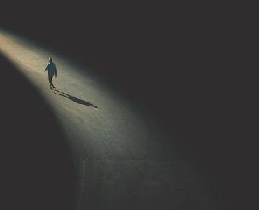 Man walking on lighted path to destination