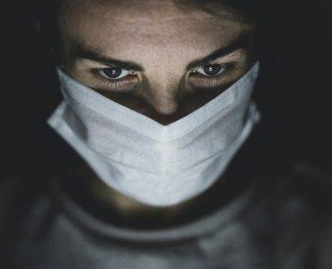 Photo of man in surgical mask by Engin Akyurt from Pexels