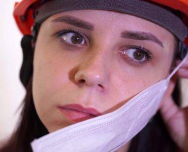 Female hardhat removing mask