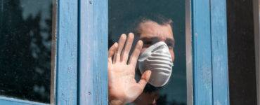 Man with mask at window