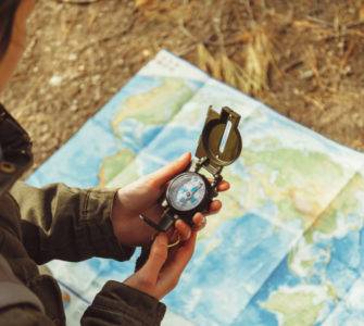 Woman using compass with map