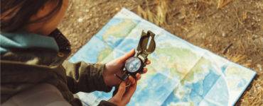 Woman using compass with map