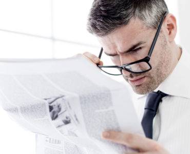 Man reading news AR hit pieces