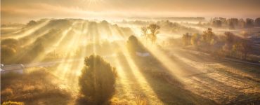 Sun spilling across fields