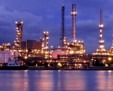 Oil refinery at night near water