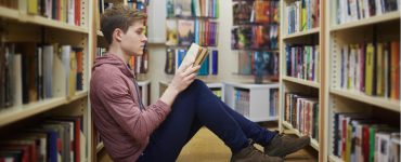 Young man reading in library